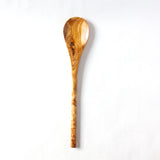 white background with an olive wood spoon