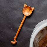 Cat shaped spoon on a black surface