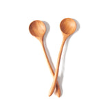two curvy wooden spoons on a white background