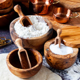wooden scoops in use with wooden bowls and salt cellar.