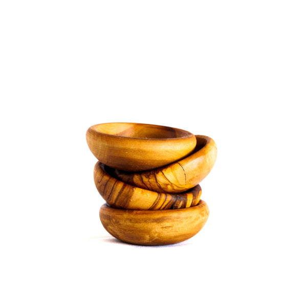 Olive Wood Pinch Bowls Set of 4  stacked on top of one another on a white background