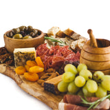 Charcuterie spread on wooden board
