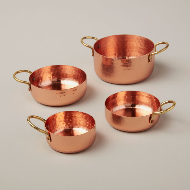 Copper and Brass Measuring Cups on a neutral background