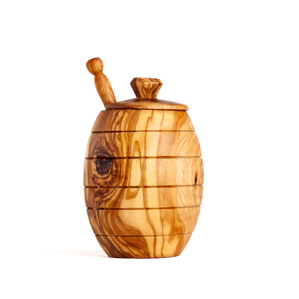 Olive wood honey pot with spoon on a white background