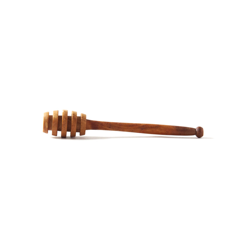 wooden honey spoon on a white background