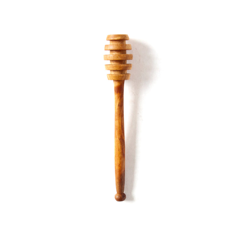 olive wood honey dipper on a white background