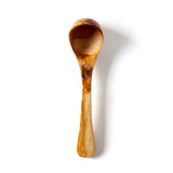 top down view of a wooden soup ladle on a white background