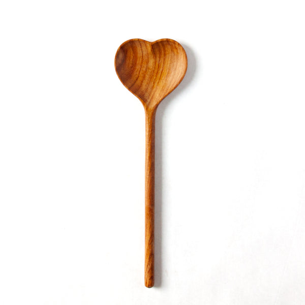 Large wooden heart spoon on a white background