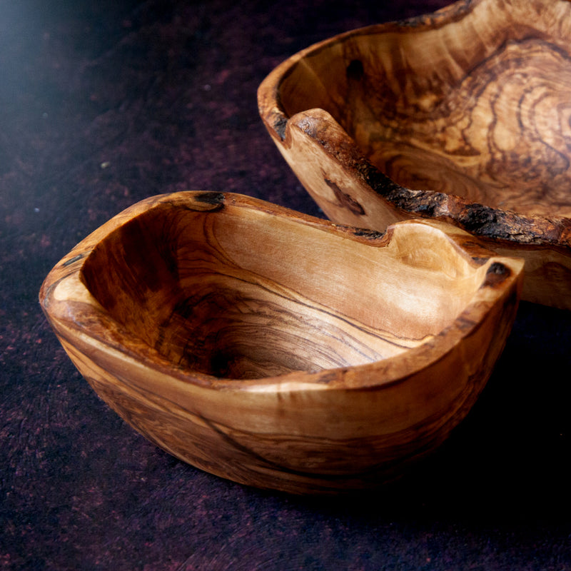 empty rustic olive wood dish on a dark background