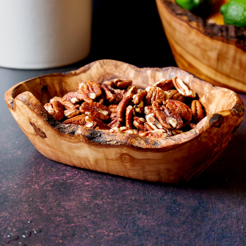 Medium Rustic Olive wood dish filled with pecans on a dark background