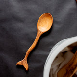 Whale tail spoon on a black background