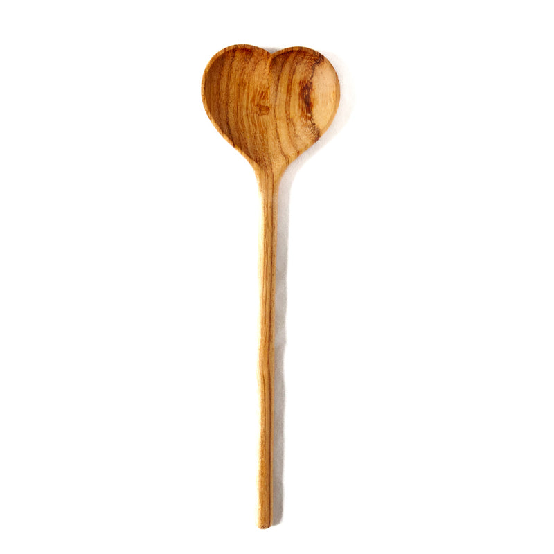 Large wooden heart spoon on a white background