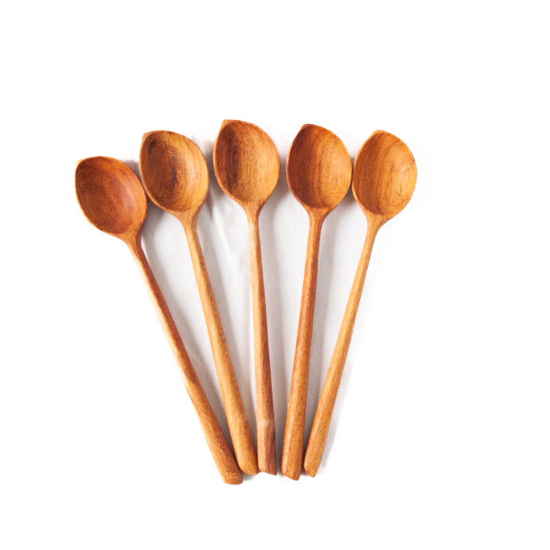 five wooden spoons with tapered points on a white background