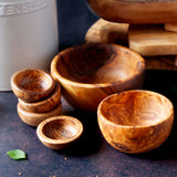 Wooden bowls of different sizes on a dark background