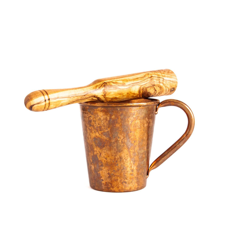 Olive Wood Drink Muddler on copper mug