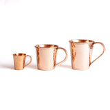 Three sizes of copper mugs