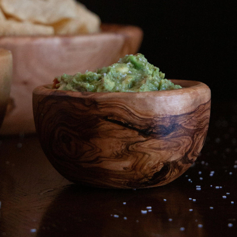 Small wood bowl filled with guacamole