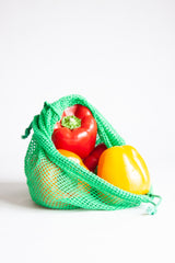 Bell peppers inside of a mesh produce bag