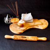 olive wood rolling pin with wood serving boards and other kitchen items