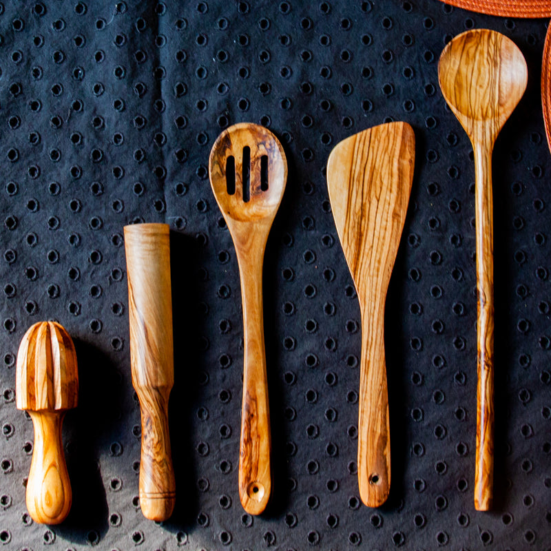 Wooden kitchen utensils on black tablecloth