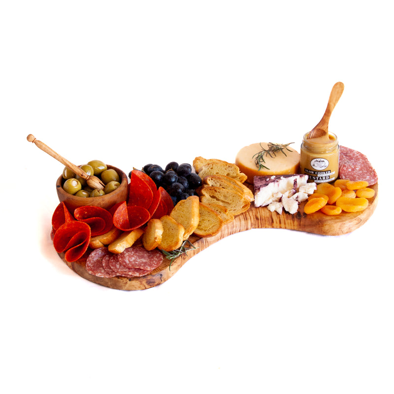Charcuterie spread with cheese, meat and olives on wooden board